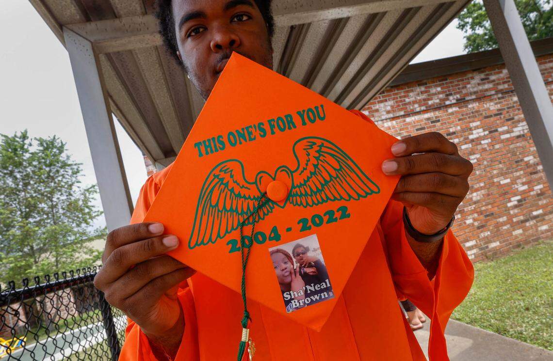 Eau Claire High School senior Tequan Green has a memorial to his friend, Sha’Neal Brown on his mortar board. Brown, along with fellow senior, Troy Ganaway died recently in separate incidents.