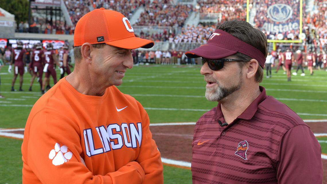 Virginia Tech Hokies head coach Brent Pry and Clemson Tigers head coach Dabo Swinney talk before the game Saturday at Lane Stadium.