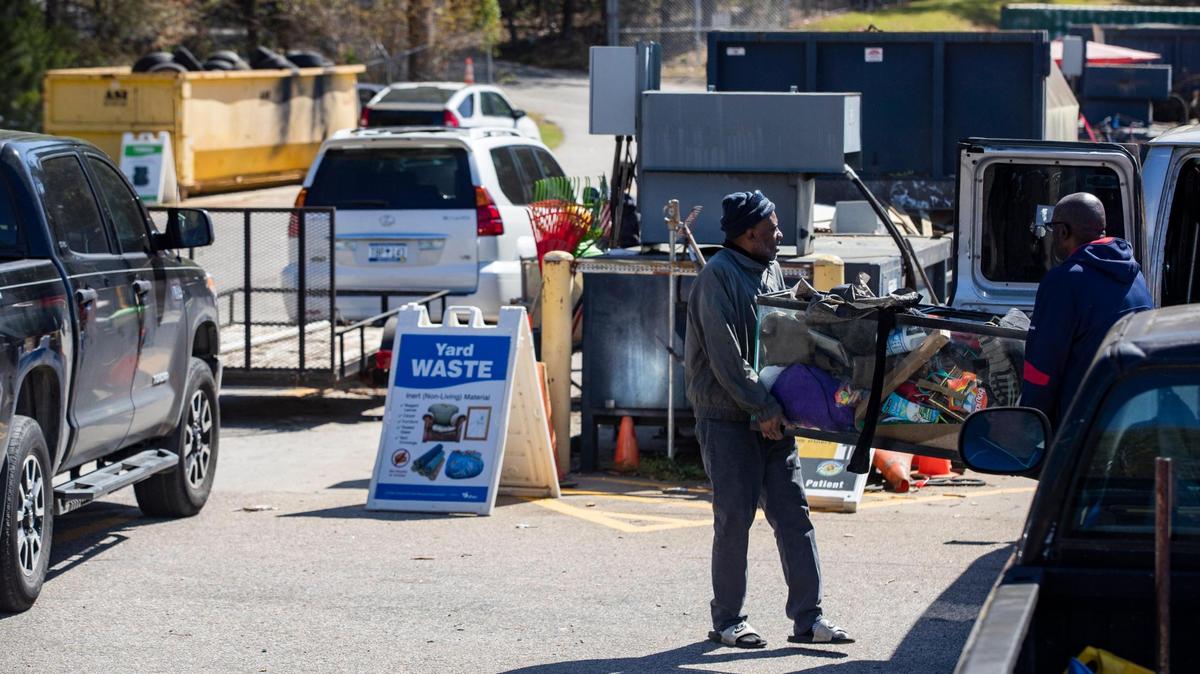 People toss their trash in Irmo, South Carolina on Saturday, April 3, 2021. While people currently bring their trash to the collection site, Lexington County may require home trash pick up.