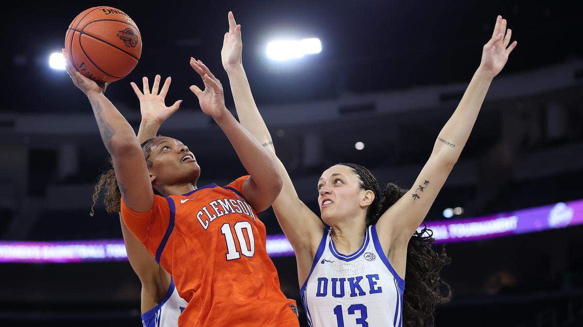 Taylor Johnson-Matthews #10 of the Clemson Tigers drives against Jordan Wood #13 of the Duke Blue Devils during the fourth quarter of the quarterfinals of the Women's ACC Tournament between the Duke Blue Devils and Clemson Tigers at Gas South Arena on March 06, 2026 in Duluth, Georgia.