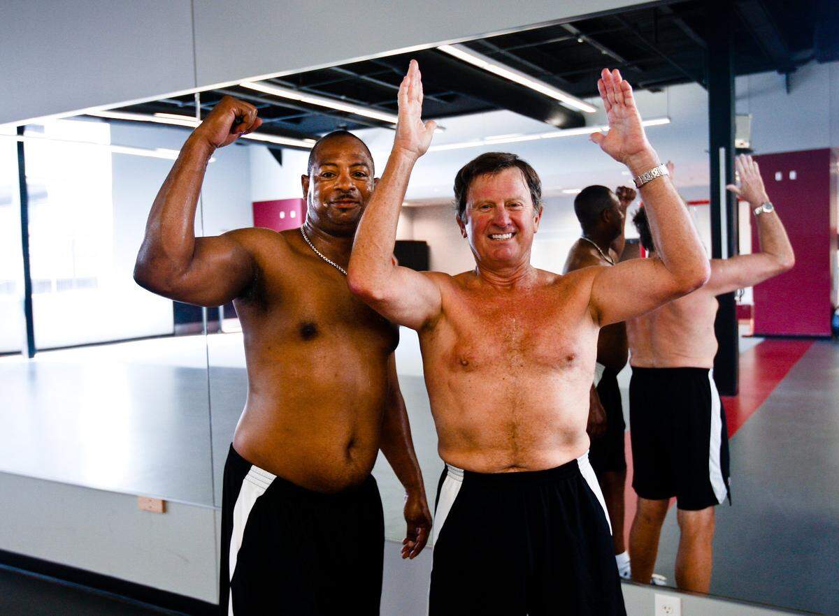 From April 16, 2010: Then-South Carolina defensive coordinator Lorenzo Ward poses shirtless with USC head coach Steve Spurrier after a workout.