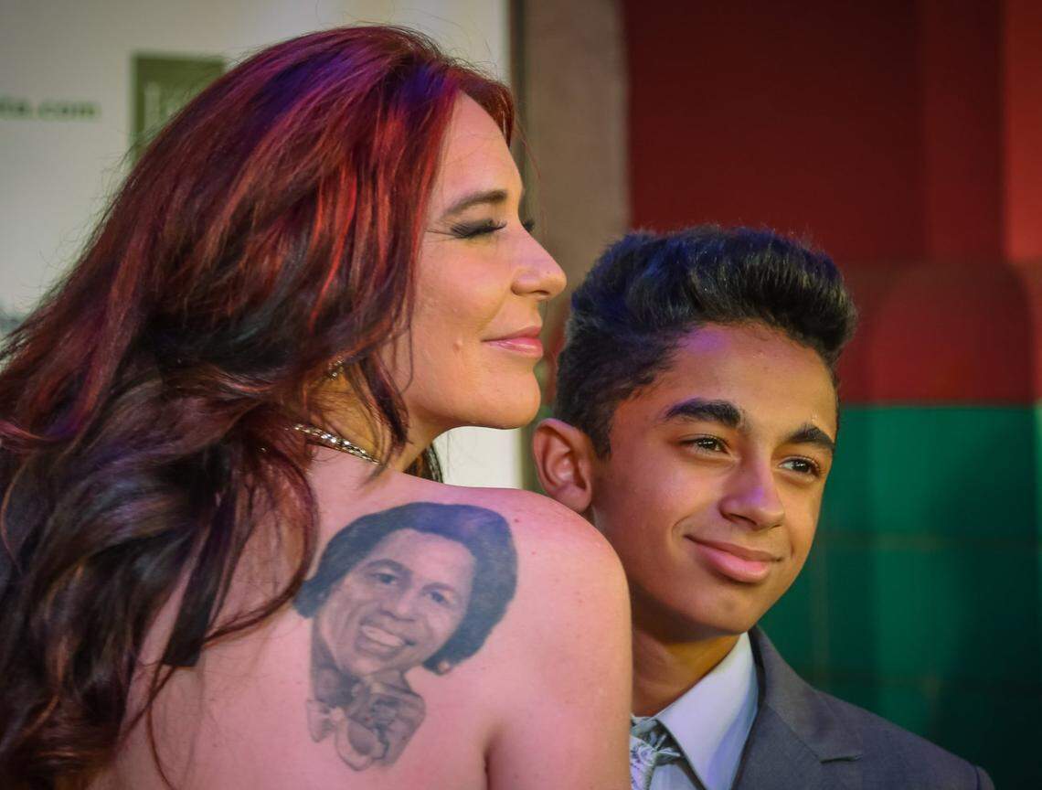 Two of James Brown’s companion Tomi Rae Hynie and their son, James Brown II,  pose on the red carpet during an Augusta, Ga. premiere of “Get On Up”, a biopic of James Brown. Those attending walked the red carpet into the theater. 7/24/14.