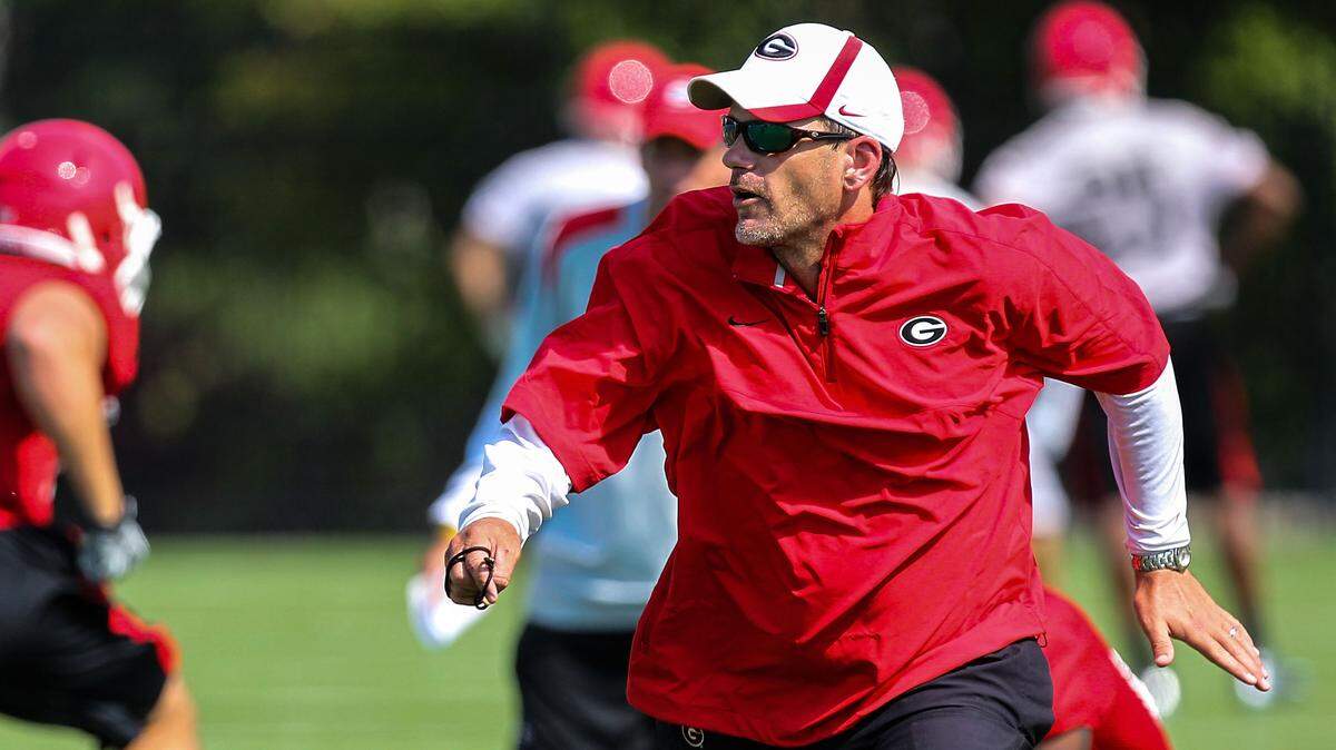 From August 2012: Georgia Bulldogs offensive coordinator Mike Bobo runs a drill during an NCAA college football practice at the University of Georgia in Athens.