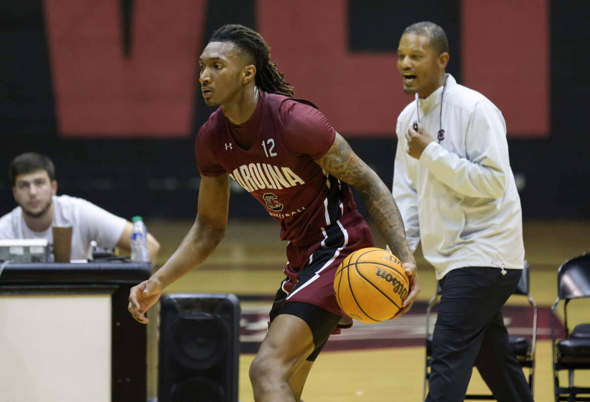Gamecock Zachary Davis brings the ball up the court as head coach Lamont Paris looks on during practice at Carolina Coliseum in Columbia on Wednesday, August 2, 2023.