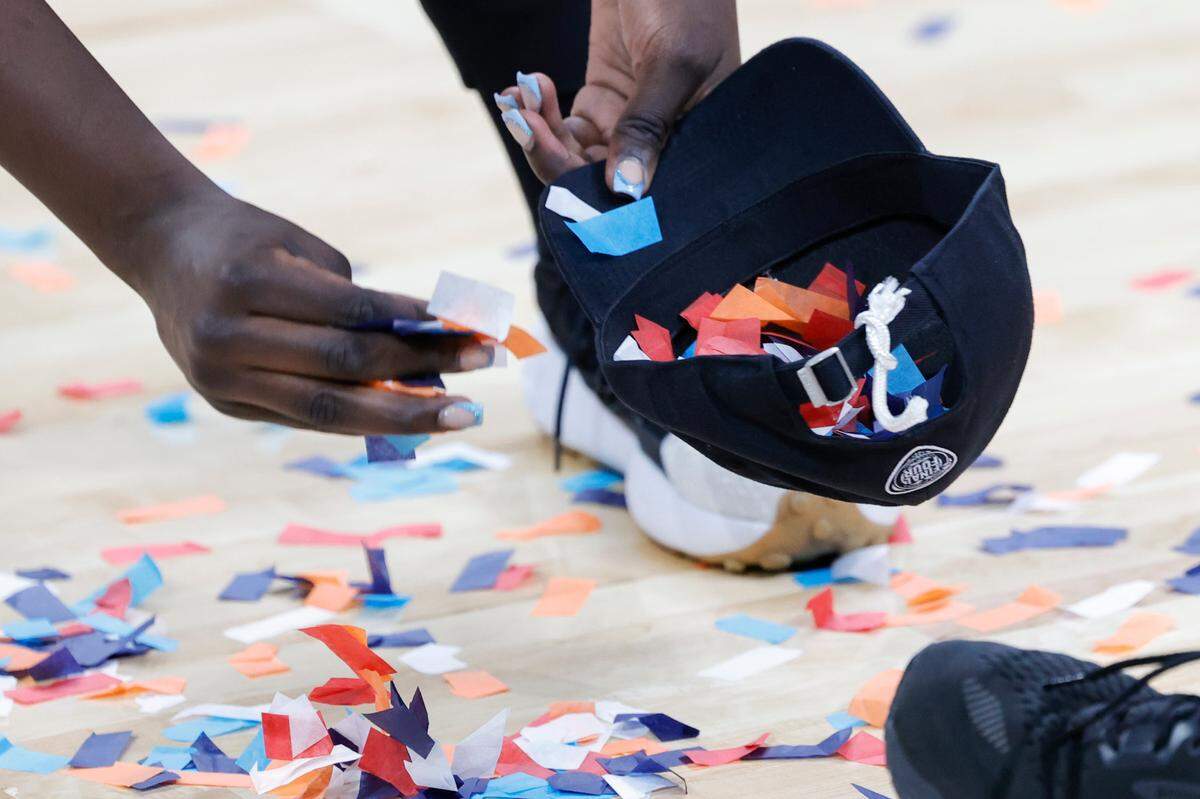 Adhel Tac picks up confetti after the Gamecocks beat Oregon State at the MVP Arena in Albany, New York on Sunday, March 31, 2024.