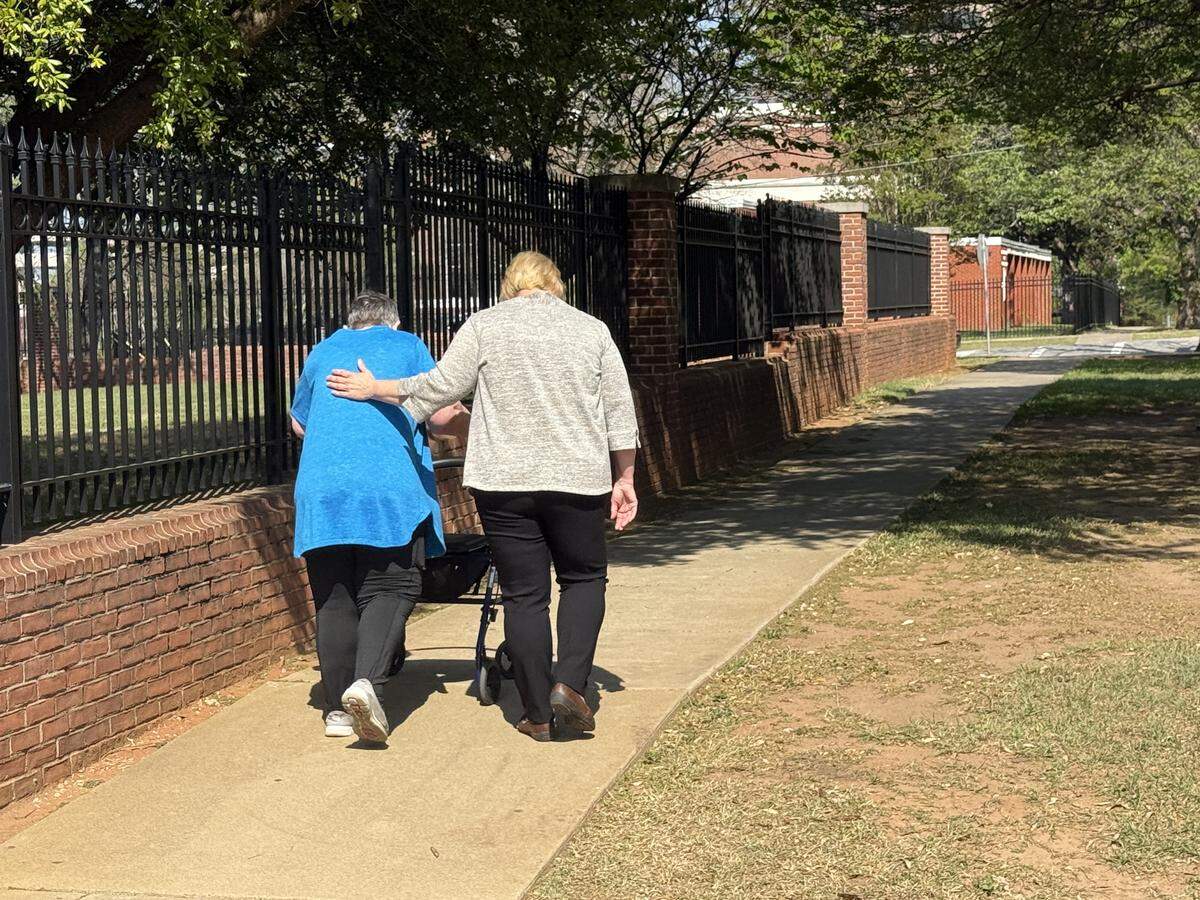 Convicted embezzler Melodie Hoover (right), 52, leaves the Columbia federal courthouse Friday with her mother, Joan Hoover, 77, after Melodie Hoover was sentenced to six -plus years in prison.