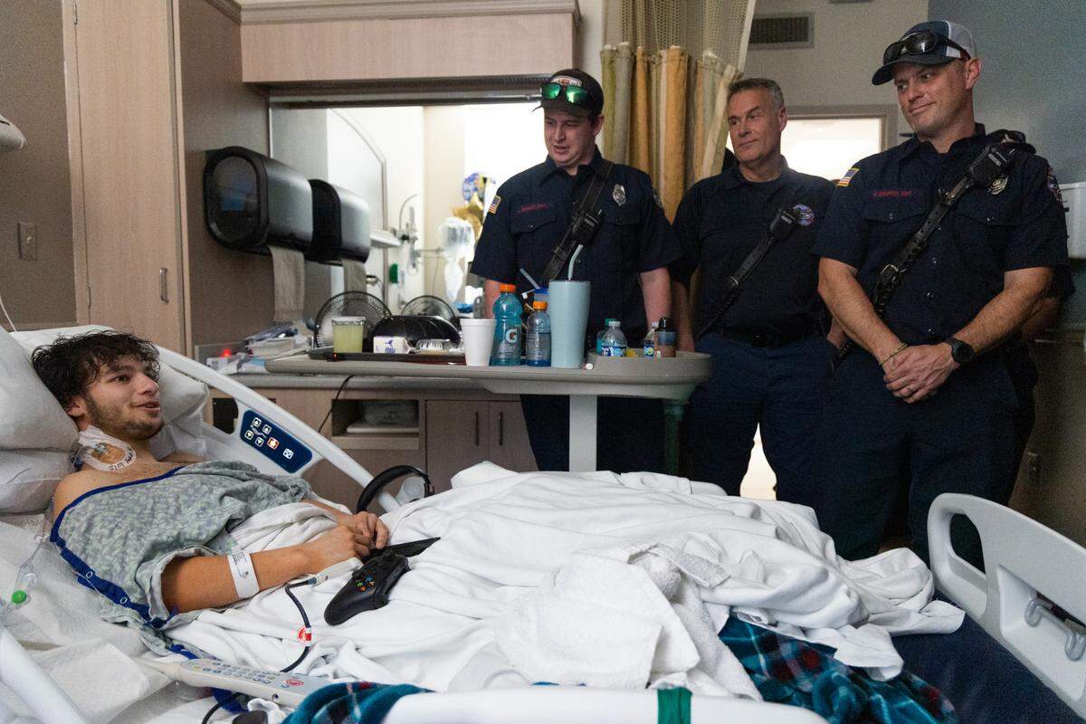 JJ Haselbarth meets the Lexington County Fire Service workers who rescued him from the car crash in his hospital room at Prisma Richland Hospital on Wednesday, March 19, 2025. Haselbarth said he hoped to one day thank the people that removed him from his car and brought him to the hospital, and was happy to hear about the accident he barely remembers.