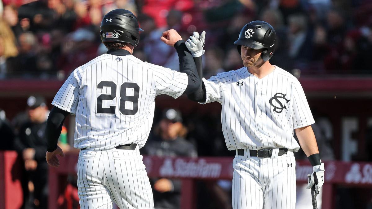 South Carolina’s Wes Clarke (28) is congratulated by teammate Brennan Milone against Holy Cross on Saturday at Founders Park.