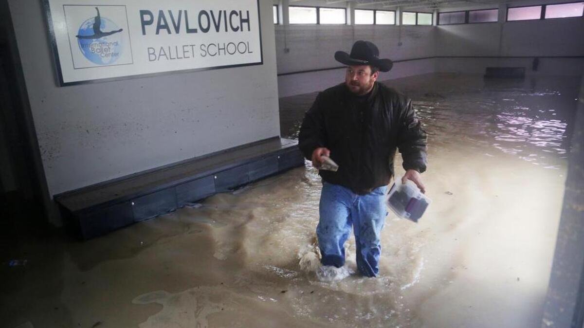 
The day after the flood, on Oct. 5, electrical workers walk through the Pavlovich Ballet School building on Devine Street. The building, home to Columbia Classical Ballet, suffered major water damage. 
