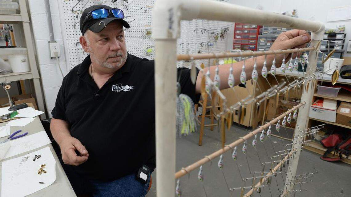 Fishing lure manufacturer Tom Mundy assembles spinnerbaits in his Laurens shop.