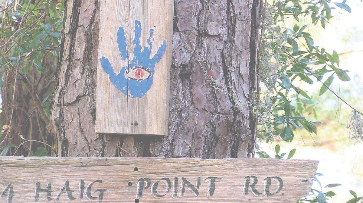 The ‘evil eye’ symbol hangs from a tree outside a home on Haig Point Road on Daufuskie Island. Both the eye and the blue-painted hand around it are believed by many Gullah people to keep evil spirits away.