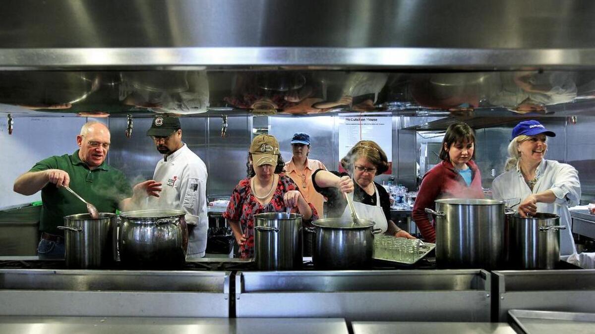 
USC’s McCutcheon House announces theor fall chef du jour classes that are open to the public. Here, Chef Brian Hay, second from left, works with students as they make homemade blueberry jam.
