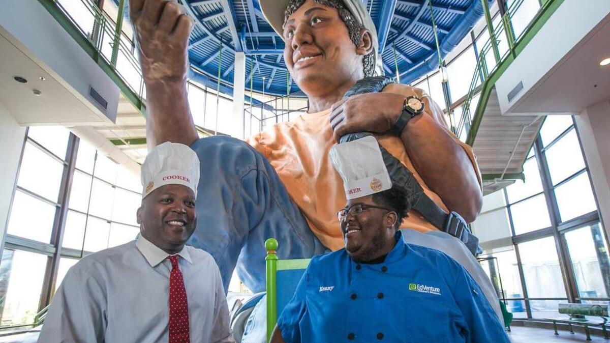 Chef Kenny Smith calls out Mayor Steve Benjamin for the 100 Men Who Cook for Kids is a fun fundraiser at EdVenture. Friendly trash talking among the men is heating up as they race to see who can raise the most money for EdVenture’s Youth Program.