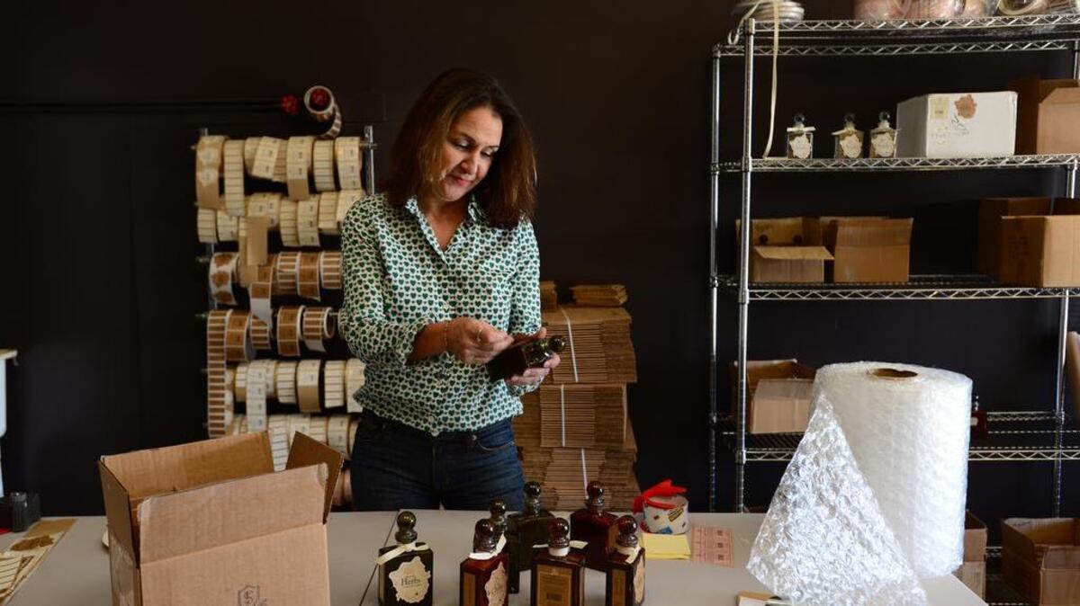 Lisa Conner labels packages of spices at her all-organic, GMO-free spice company called Spice Society.
