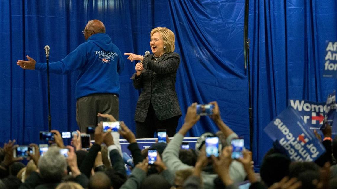 Democratic presidential candidate Hillary Clinton points to a supporter after she is introduced by Rep. Jim Clyburn (D-SC), left, before she speaks to a crowd at the Jim Clyburn Fish Fry, on Saturday, Jan. 16, 2016, at the Charleston Visitor Center in Charleston, S.C.