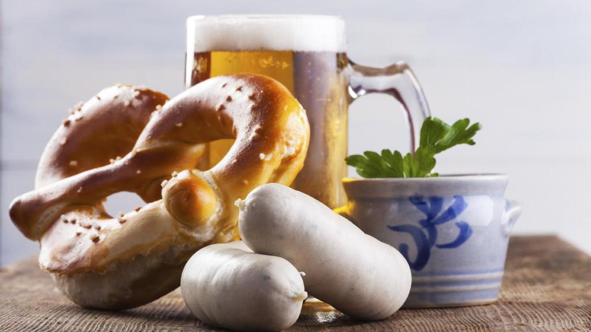 Bavarian white sausages with pretzel and beer are some of the traditional foods you will find during Oktoberfest.
