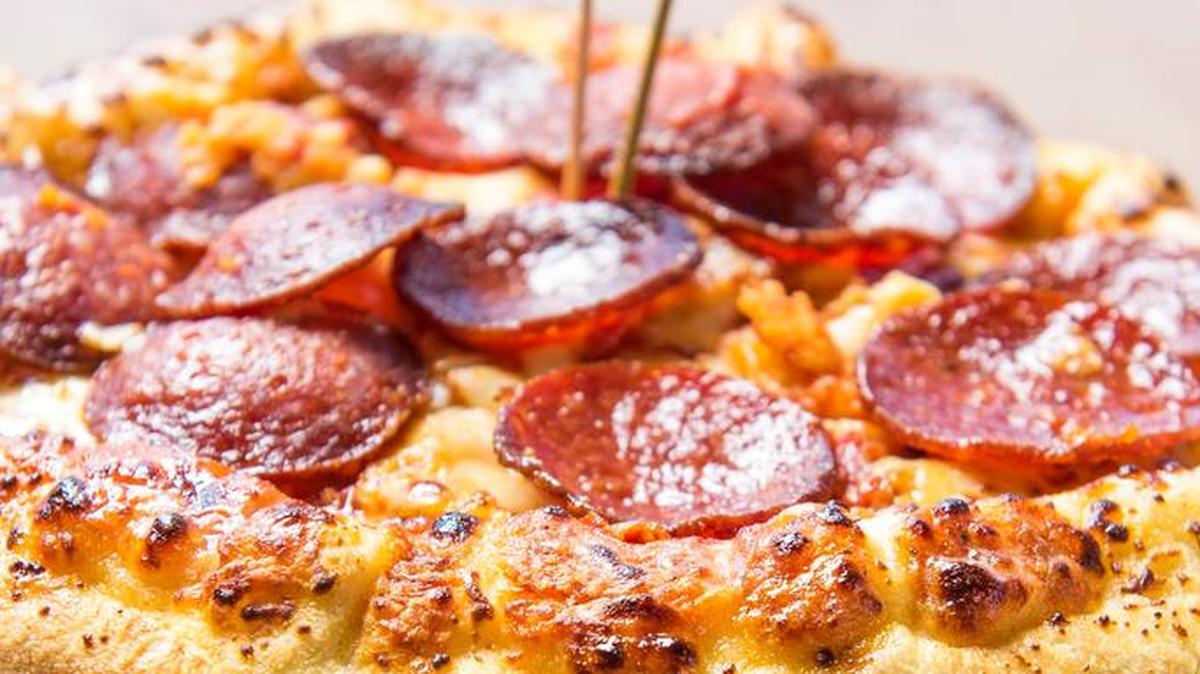 In this March 22, 2016 photo released by the Atlanta Braves, the "Burgerizza" is shown in Atlanta. A grilled 20oz. all beef patty, covered with five slices of cheddar cheese, topped with crispy bacon, and served between two 8-inch Pepperoni Pizzas is one of many new items that will be for sale at the stadium.