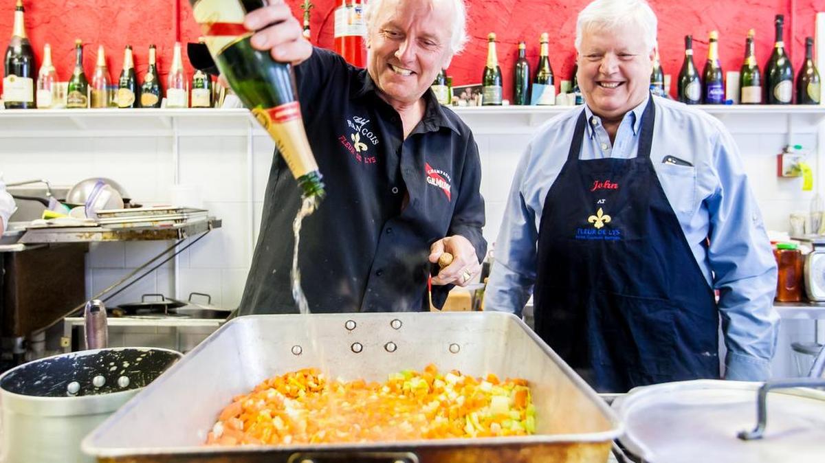 ‘Just a little champagne!’ jokes Chef Francois Fisera, left, as he pours nearly a whole bottle into a pan of mixed vegetables during cooking class at the Fleur de Lys Home Culinary Institute.