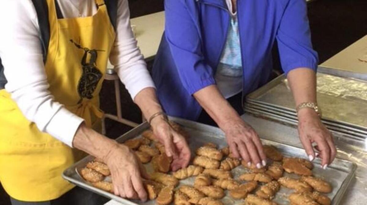 Olga Augustinos, left, and Niki Psomas prepare koulourakia for the St. Katherine’s Philoptochos Bake Sale and Luncheon. The annual event is March 24 at Holy Trinity Greek Orthodox Church.