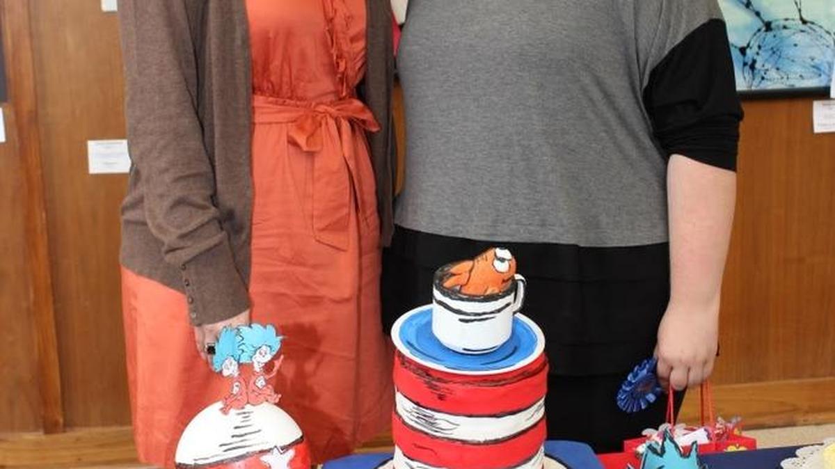 2015 Literary cake Decorating Contest winner Danielle Potter, right, with State Library Acting Director Leesa Aiken.