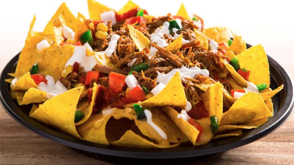 Taco John’s Super Nachos: a mountain of freshly cooked tortilla chips covered in nacho cheese, 100% American beef, refried beans, cheddar cheese, tomatoes, black olives, guacamole and rich sour cream.