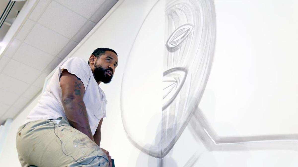Artist Cedric Umoja works on a piece inside Goodall Gallery at Columbia College.