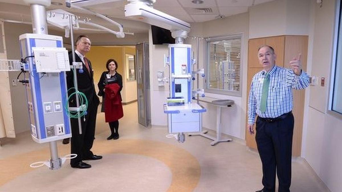 Facilities project manager Jessie Owens, right, gives a tour of the first phase of the newly remodeled Greenville Health System Intensive Care Unit to GMH employees David Sudduth and Allison Greene after a ribbon cutting on Monday, January 26, 2016.