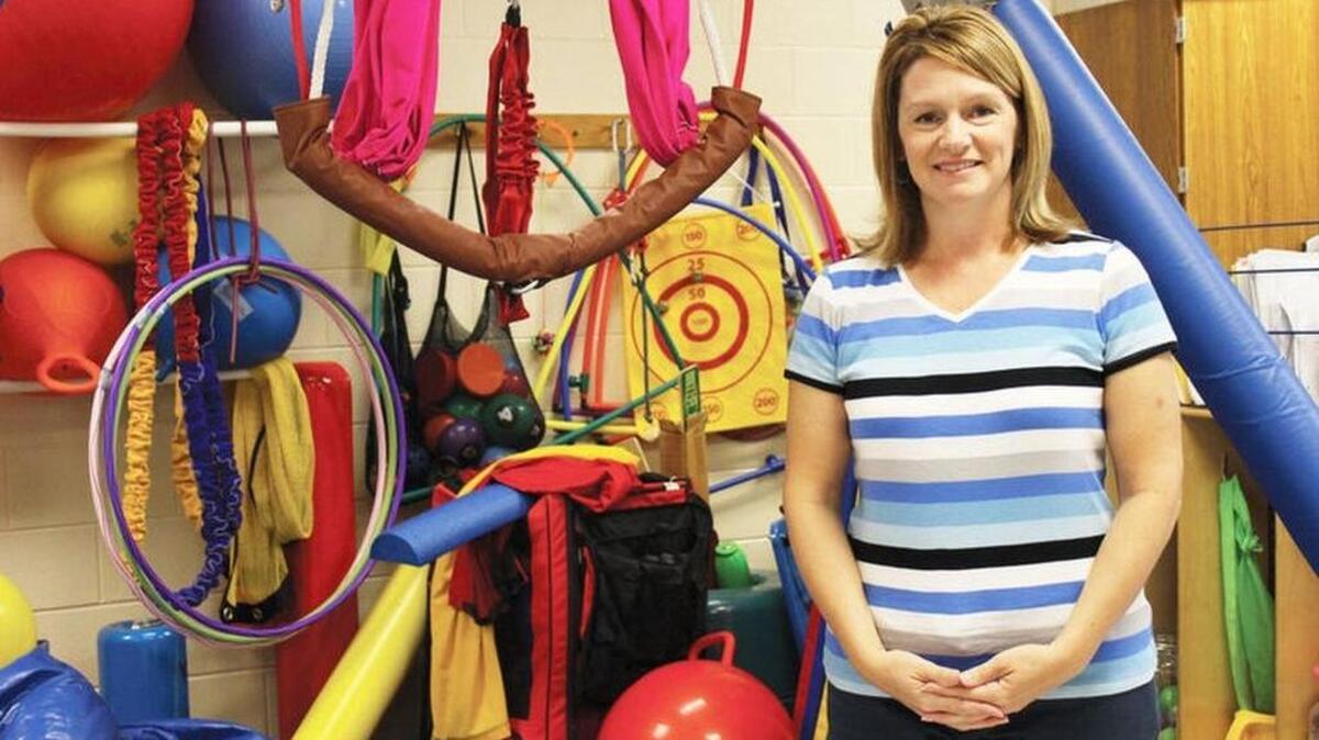 Physical Therapy Assistant Kari Wise says there is nothing more rewarding than the work she does in Florence School District One helping students with a variety of special needs. Wise is pictured with the tools of her trade including hula hoops and bouncing balls.