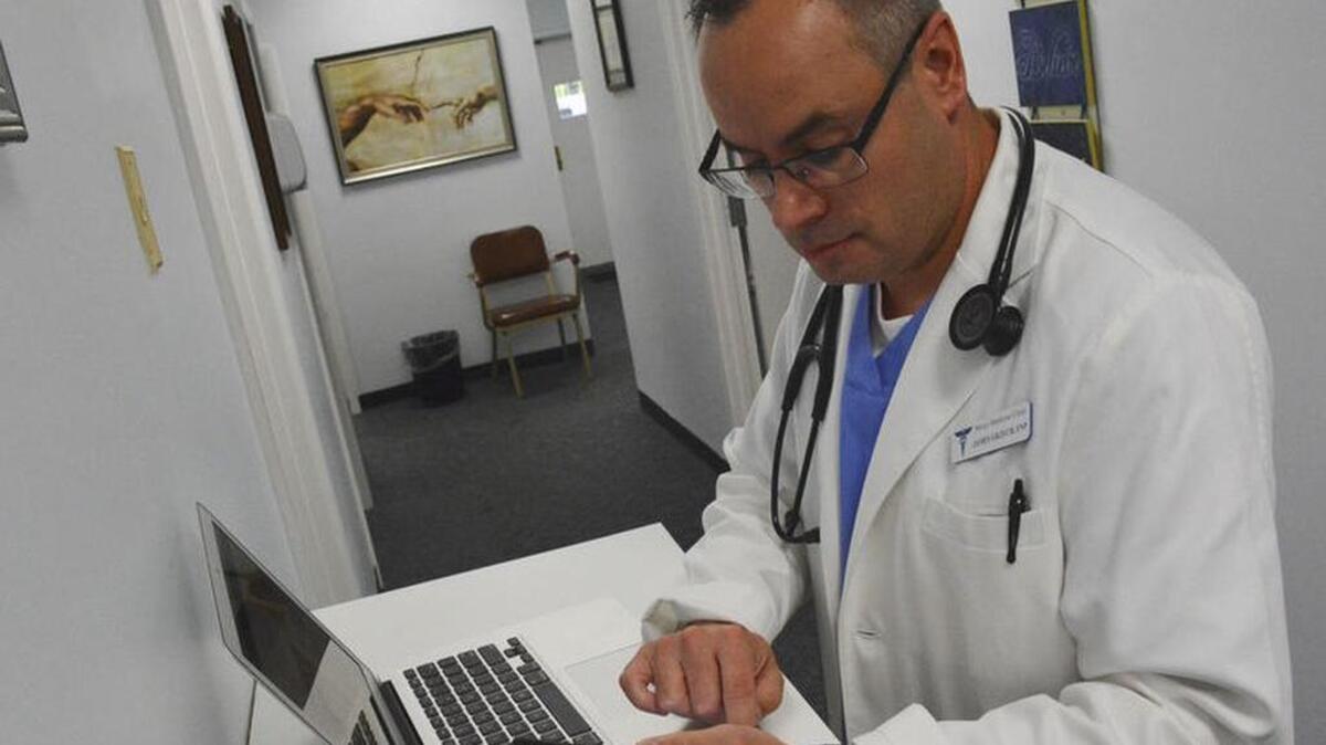 
Mercy Medicine Family Nurse Practitioner James Grzech sends a text using the new CareMessage patient texting system, implemented on Wednesday, August 26, 2015 in Florence.
