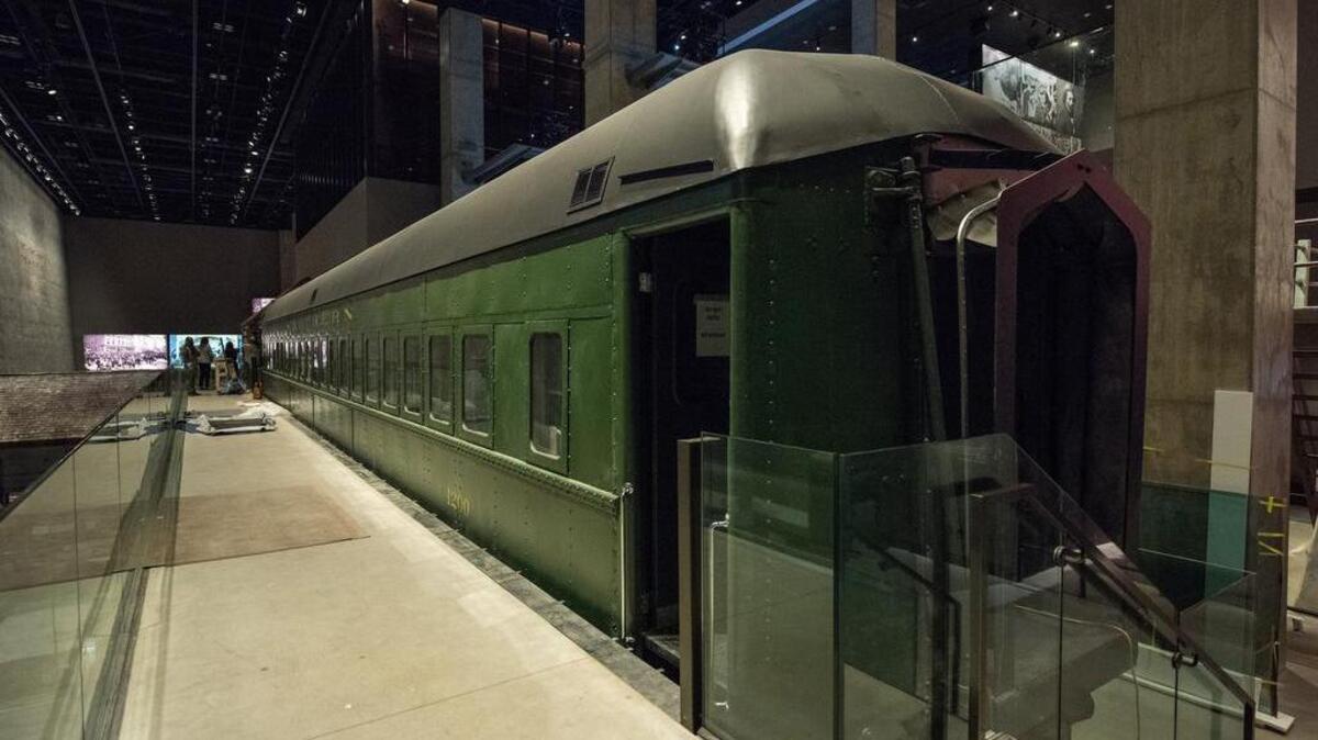 A Jim Crow-era segregated passenger train coach restored is on display at the Smithsonian’s National Museum of African American History and Culture.