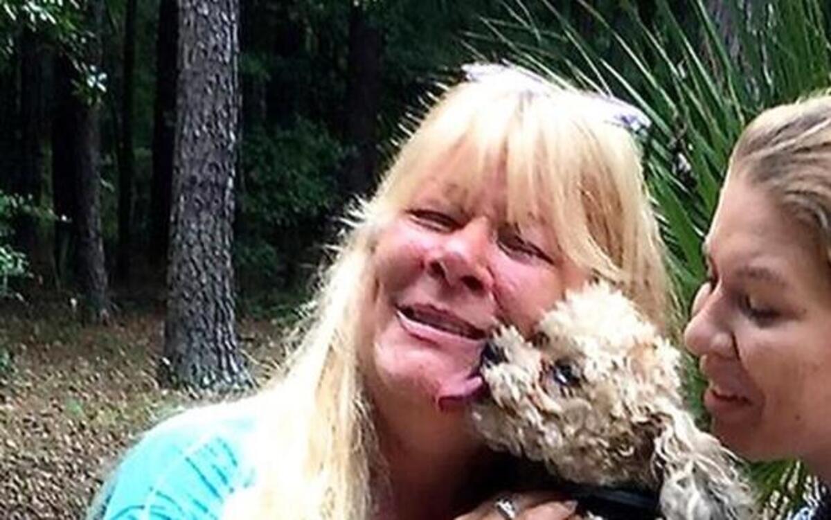 
Five-pound Louie is reunited with his owner, Susan Nolan, who was staying on Daufuskie Island with her daughter, Taylor, right, when Louie disappeared for eight days in the woods. Residents had worried the little dog had become prey to one of Daufuskie's many wild creatures. 
