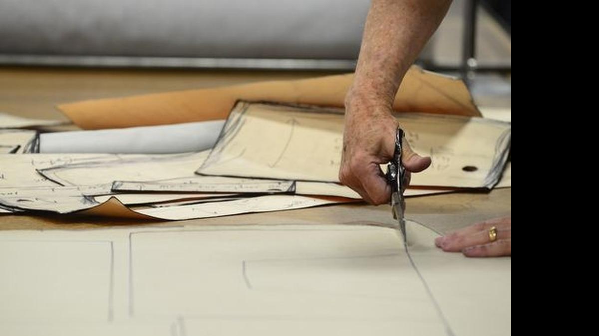 
John Smith and Ray Foster cut patterns out of fabric in the warehouse at Snoozer, a local company that makes high-end dog beds and dog travel supplies. 
