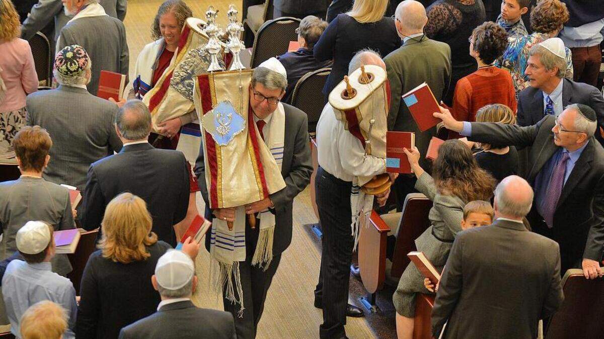 
Jews around the world continued their celebration Monday of Rosh Hashana - the Jewish New Year. Often called the birthday of the world, the holiday began Sunday at sunset. At Charlotte’s Temple Beth El, members reverently touched the Torah – sacred parchment scrolls containing the first five books of the Hebrew Bible – with a tallit (prayer shawl) or prayer book.
