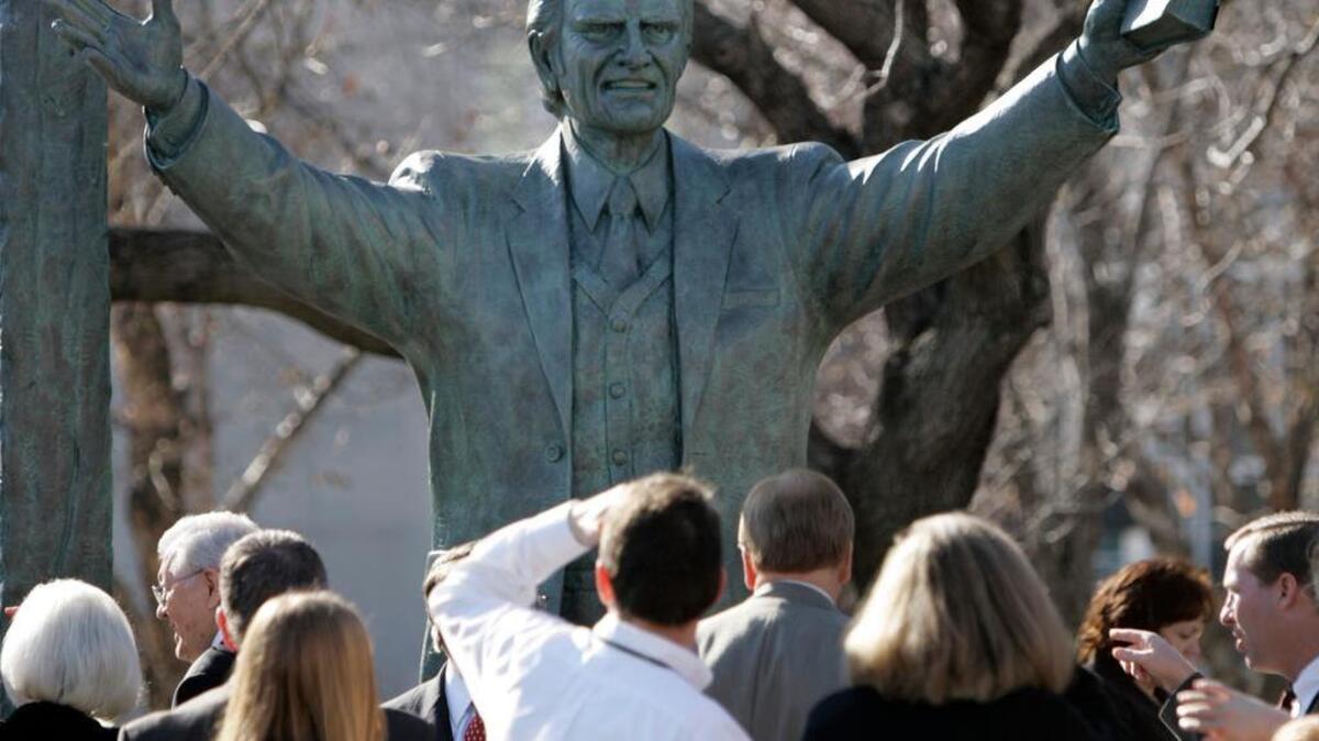 
A bronze statue of evangelist Billy Graham towers above a crowd gathered to see its unveiling in Nashville, Tenn., Wednesday, Dec. 13, 2006. The statue is located on a street corner on the campus of LifeWay Christian Resources, the publishing arm of the Southern Baptist Convention. (AP Photo/Mark Humphrey)
