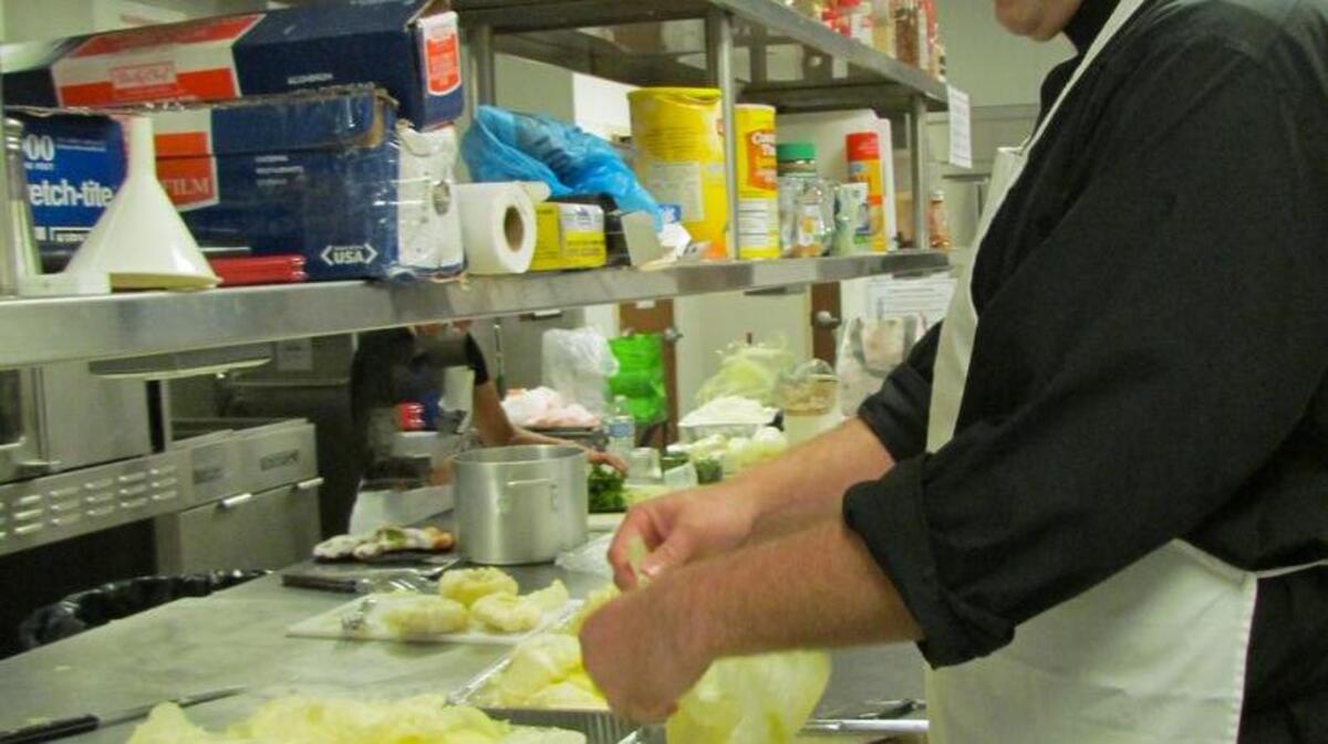 
The Rev. Roger Morgan, Parochial Vicar at Our Lady Star of the Sea Catholic Church in North Myrtle Beach, helps separate cabbage leaves in the church’s kitchen. The Ladies Guild will sell frozen cabbage rolls at the Craft Fair in November. 
