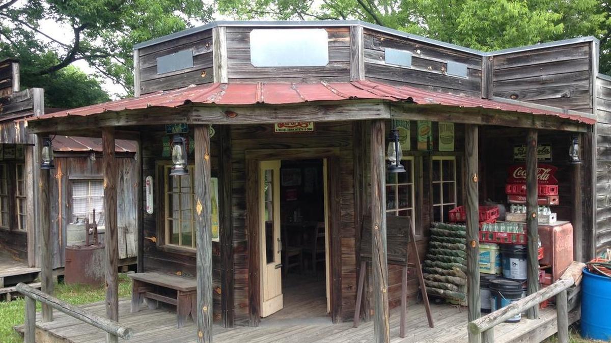 Among buildings in the western town are a general store, a bunkhouse, a chapel, a bank, a jail, a livery stable, an outhouse.