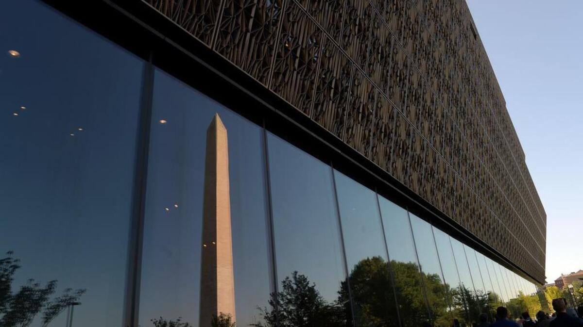 The Washington Monument is reflected in a window of the National Museum of African American History and Culture in Washington on Sept. 14 during a press preview.