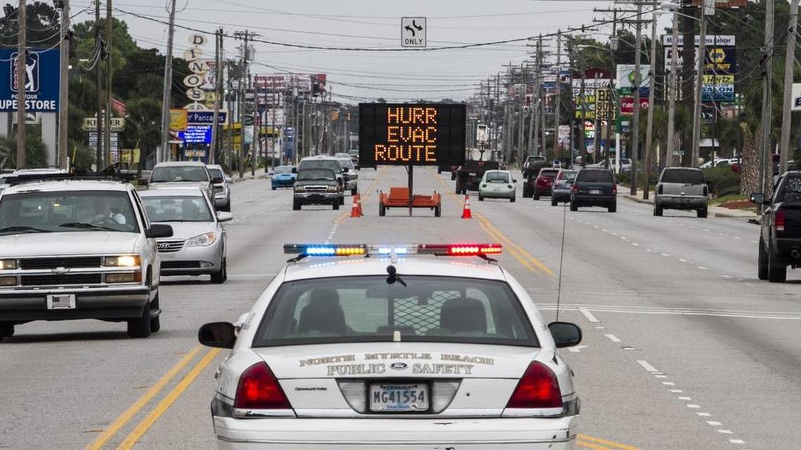 North Myrtle Beach public safety officials line U.S. 17 Business in North Myrtle Beach with signs indicating evacuation routes in advance of Hurricane Matthew's effects in October 2016.