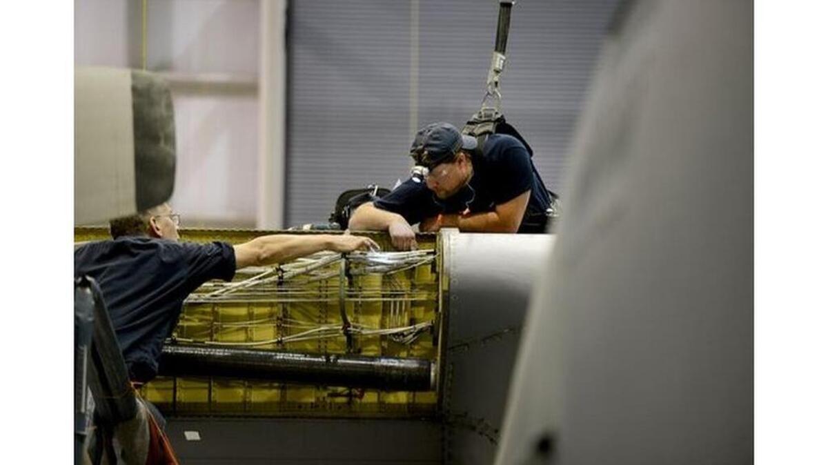 Carlo Graff, left, and Steve Kosinski work on a C130H at Lockheed Martin in Greenville on Wednesday, March 30, 2016.