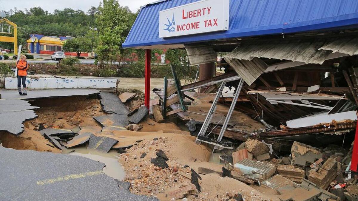 
Shelley Manning looks at the damage to Liberty Income Tax building on Garners Ferry Road in Columbia, SC, Monday, October 5, 2015. Manning's father Edward Smoak owned the building for 25 years when it was a video store prior to Liberty. 
