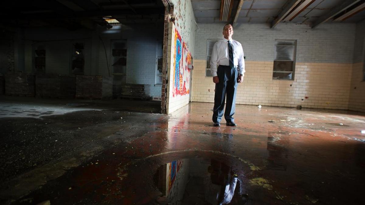 Erin Roussey, president of US Building Innovations, stands inside an old school in Newry he is redeveloping for his company.