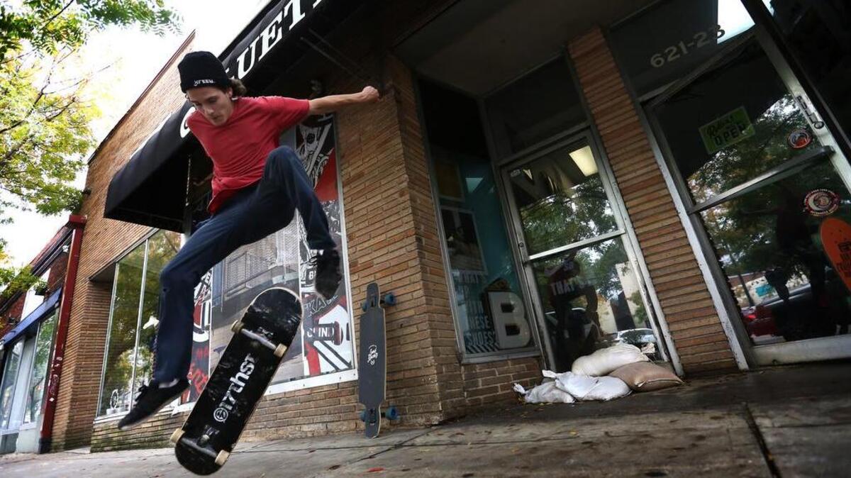 Erik Akeyson attempts a kickflip after shopping at Bluetile Skateshop on Harden Street in Five Points.