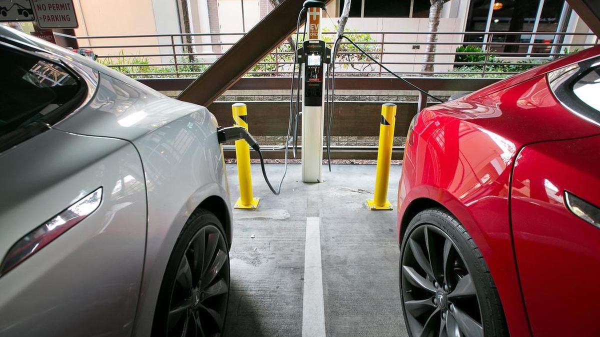 Two Tesla EVs charge at the City of Palo Alto EV charging station in the public garage at 532 Webster St. in Palo Alto, Calif., in November 2015.