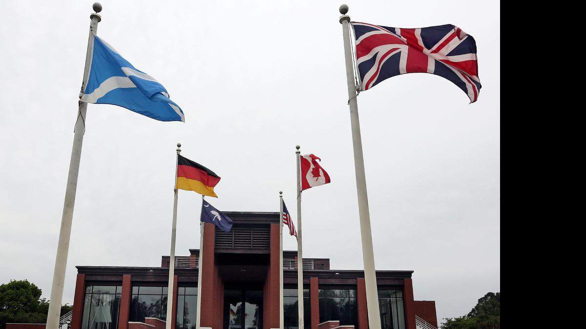
Flags fly outside of the Wild Wing club house on Monday. The course and land has been recently sold. 
