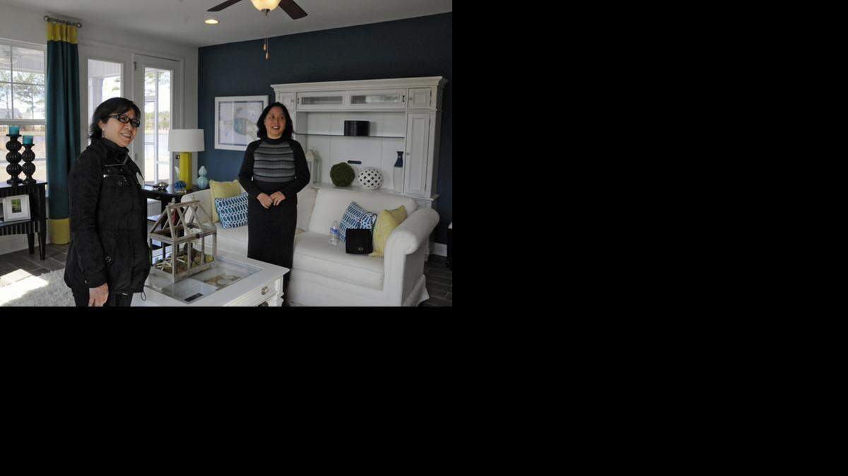
Mei Huang, left, tours a model home at The Farm in Carolina Forest with realtor Jane Zheng.
