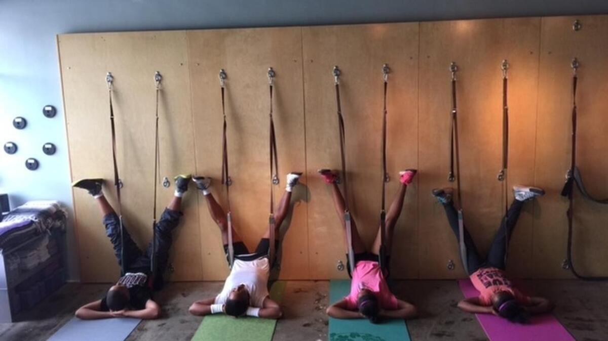A family stretches on the yoga wall at Fit Columbia. The locally owned fitness center relocated from Devine Street to Blossom Street last month.