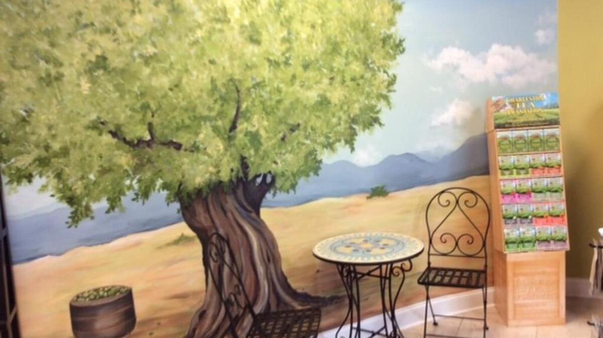 Tuscan landscape murals at The Classy Cruet’s new location in Hope Ferry Center were created by Chapin artist Susan Brush.