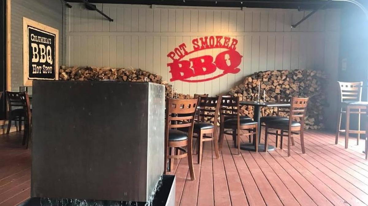 Patrons can sit outside of The Pot Smoker BBQ restaurant in the Vista.