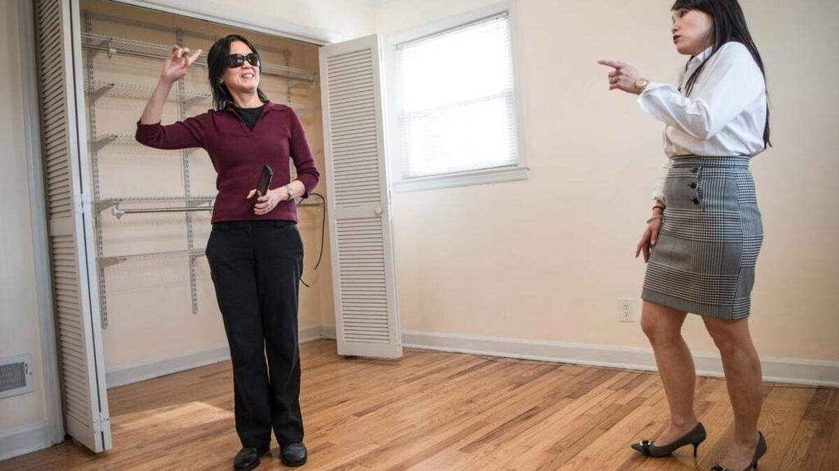 Homeowner Mel Go, left, talks with her realtor Karen Yip in a bedroom of her house near Atlas Rd. on Wednesday, March 22, 2017, in Columbia, S.C.
