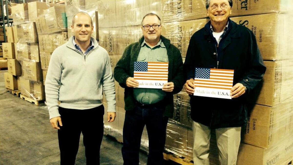 USA eShop chief operation officer, John Wilkinson, Snoozer Pet Products president, Gary O’Donnell and USA eShop CEO Jerry Smith stand beside shipment of Piedmont pet products bound for Europe.